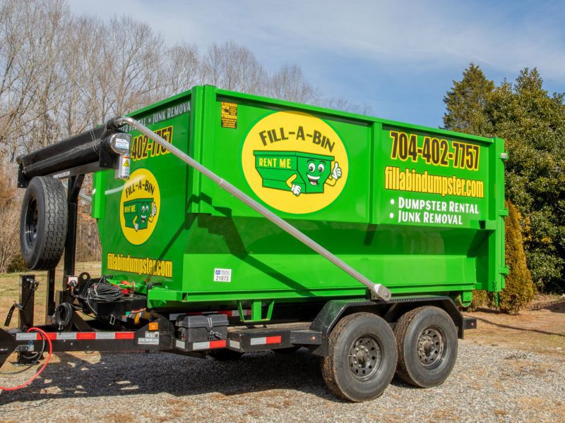 The Fill-a-Bin dumpster with the logo and emblems painted on.