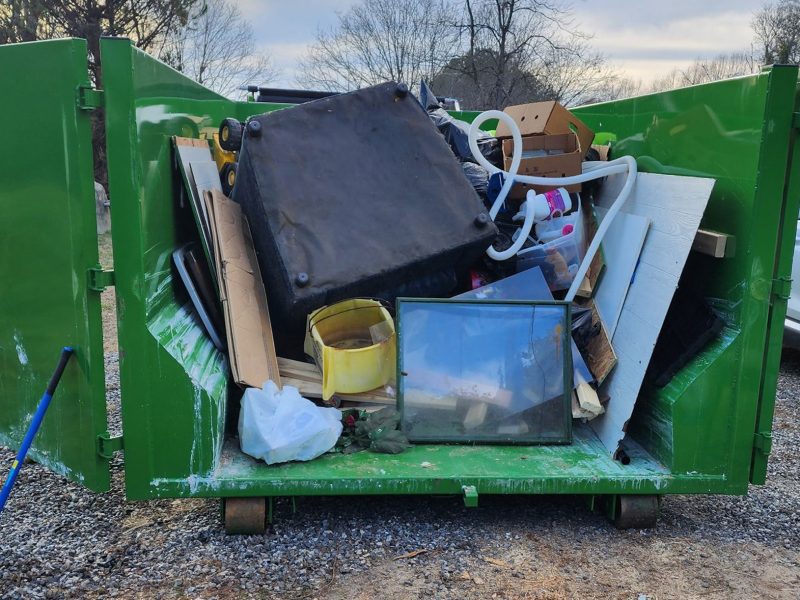 The Fill-a-Bin rental bin full of household garbage and scraps.